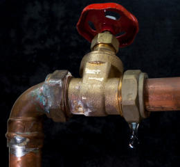 Copper water pipe dripping at the joint with a stop valve